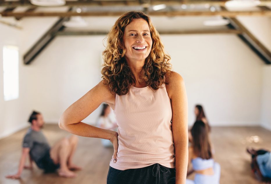 Mature woman standing in a fitness studio